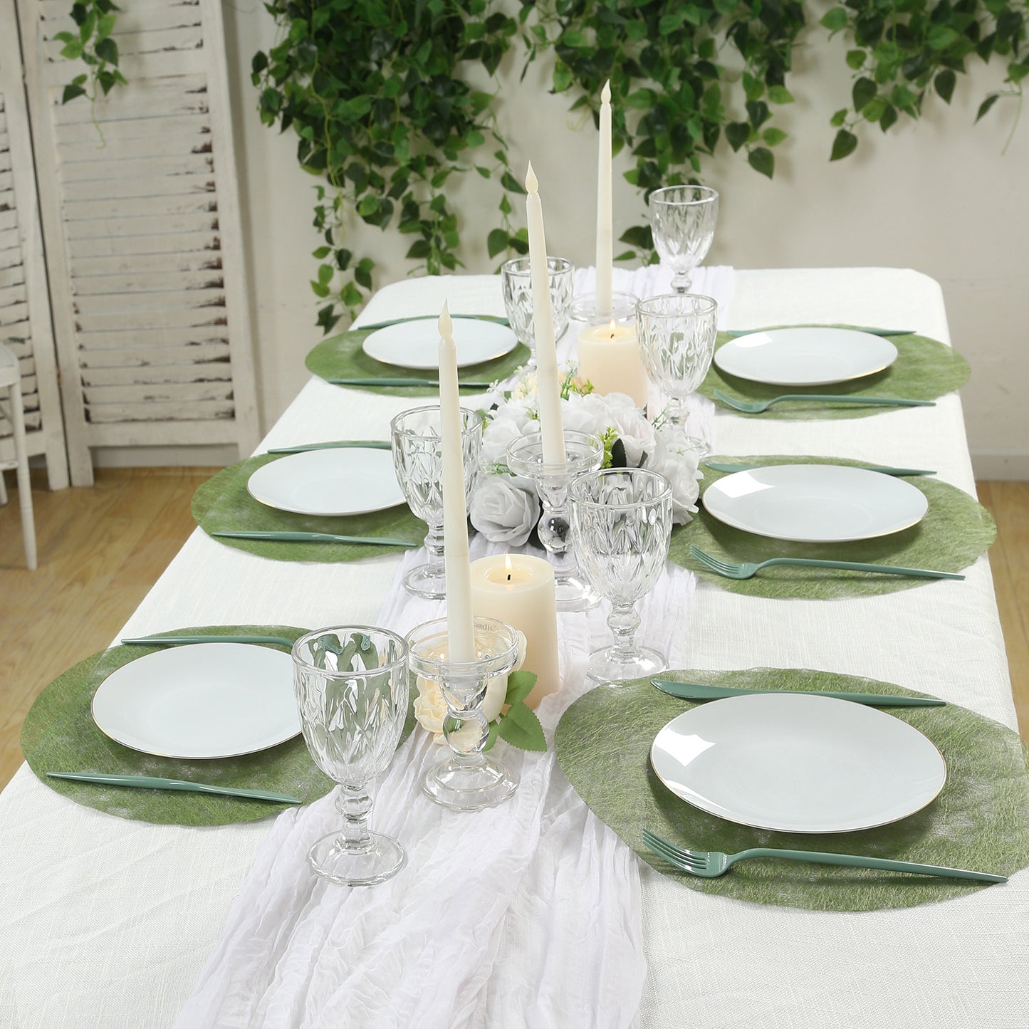 Olive green disposable placemats on a dining table setting.