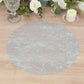 Metallic silver round placemat on a wooden table.