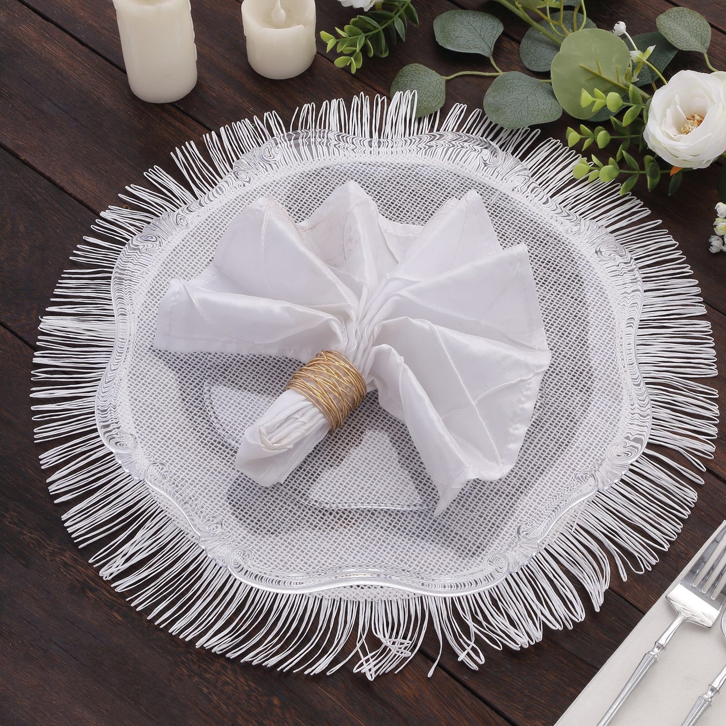 White rustic burlap tassel table mat with fringe edge on a wooden table.