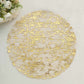 Gold foil round disposable placemat with a shiny finish.