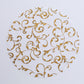 Metallic gold sheer organza placemat with embossed foil flower design.