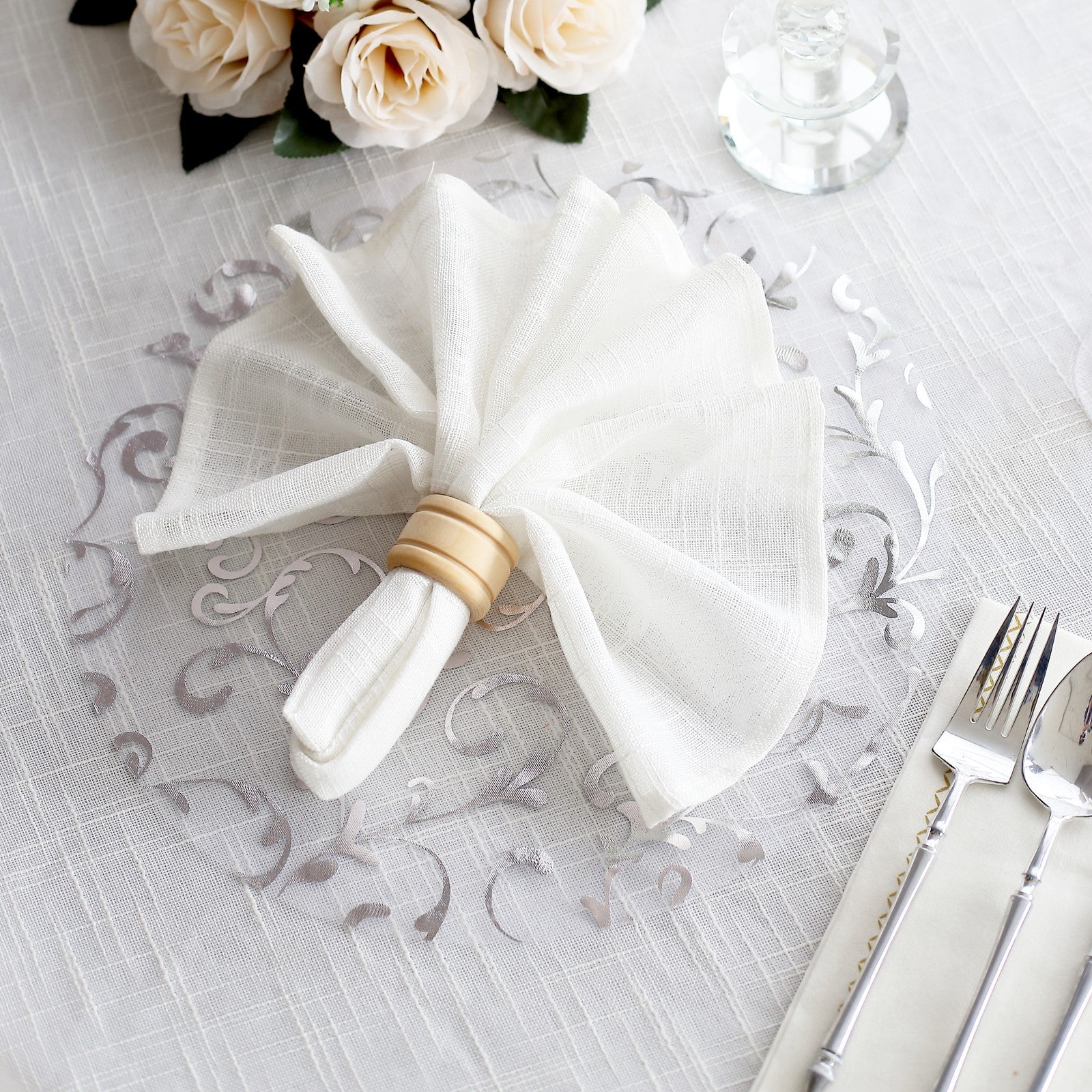Metallic silver sheer organza table mat with embossed floral design.
