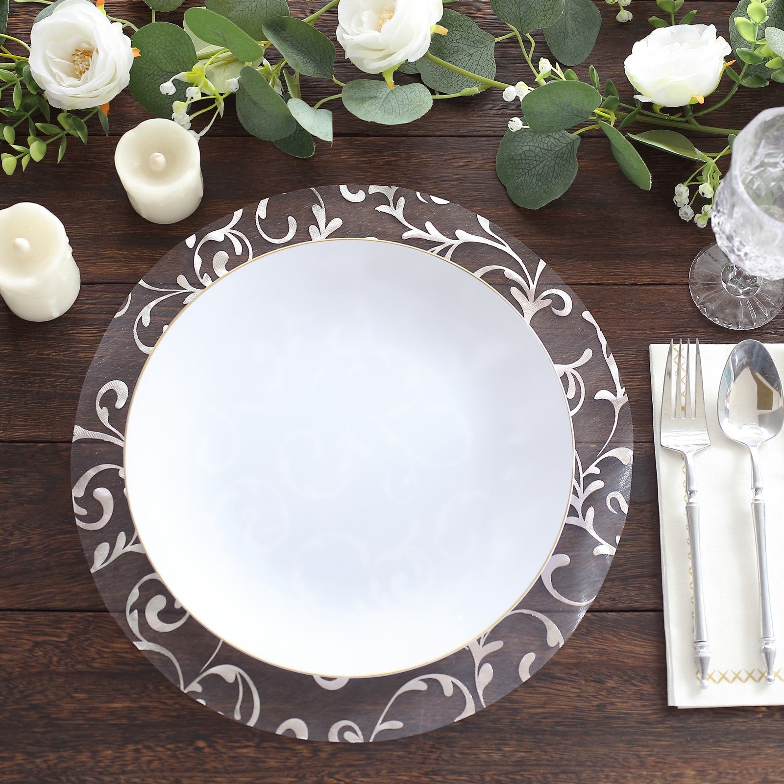 Metallic silver sheer organza placemats with embossed flower design on a dining table.