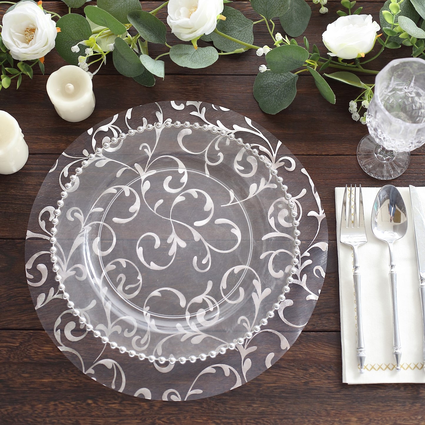 Metallic silver sheer organza table mat with embossed flower design, 13" round.