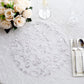 Metallic silver sheer organza round placemat with embossed floral design.