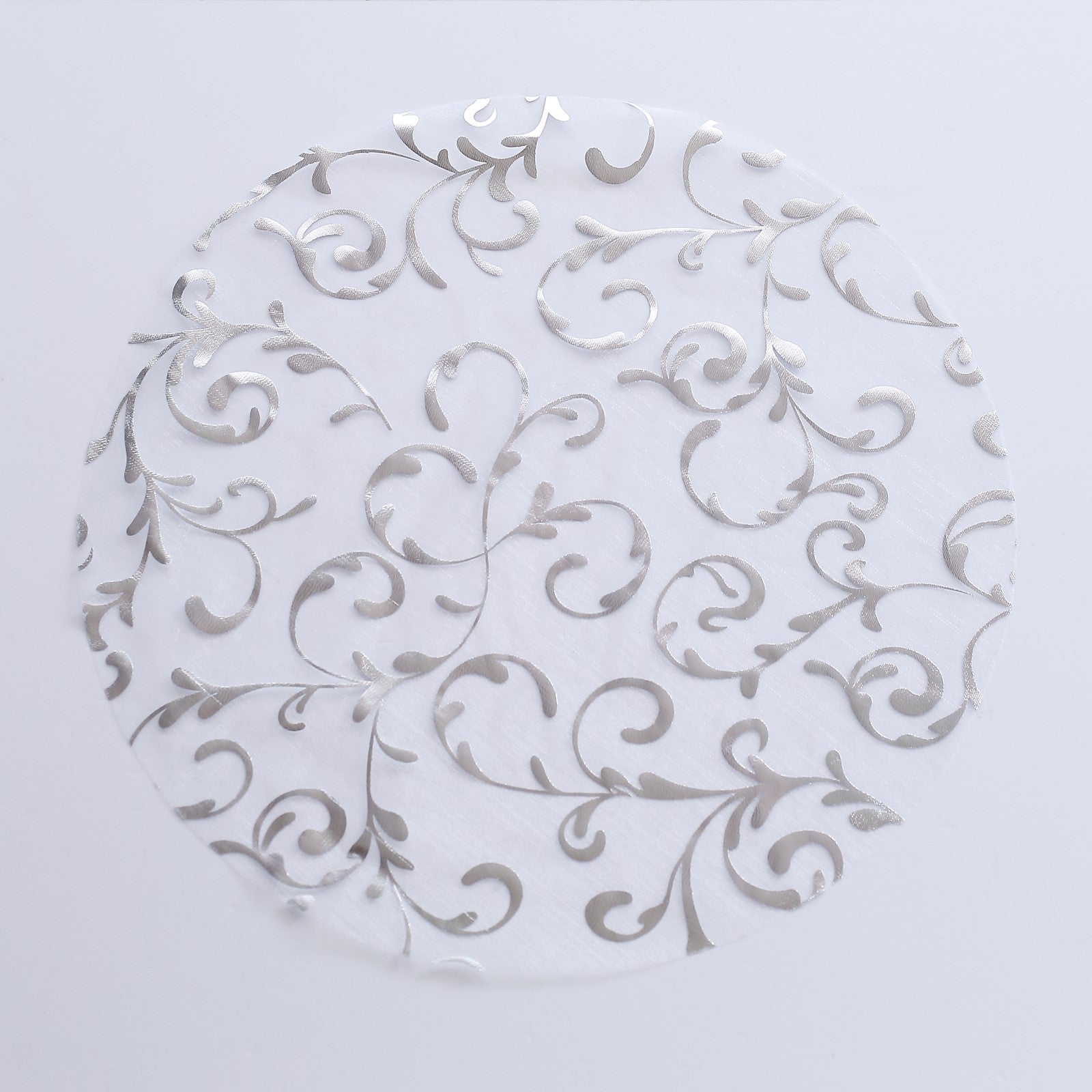 Metallic silver sheer organza placemat with embossed foil flower design.