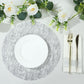 Metallic silver glitter round table mat with white plate and silver cutlery.