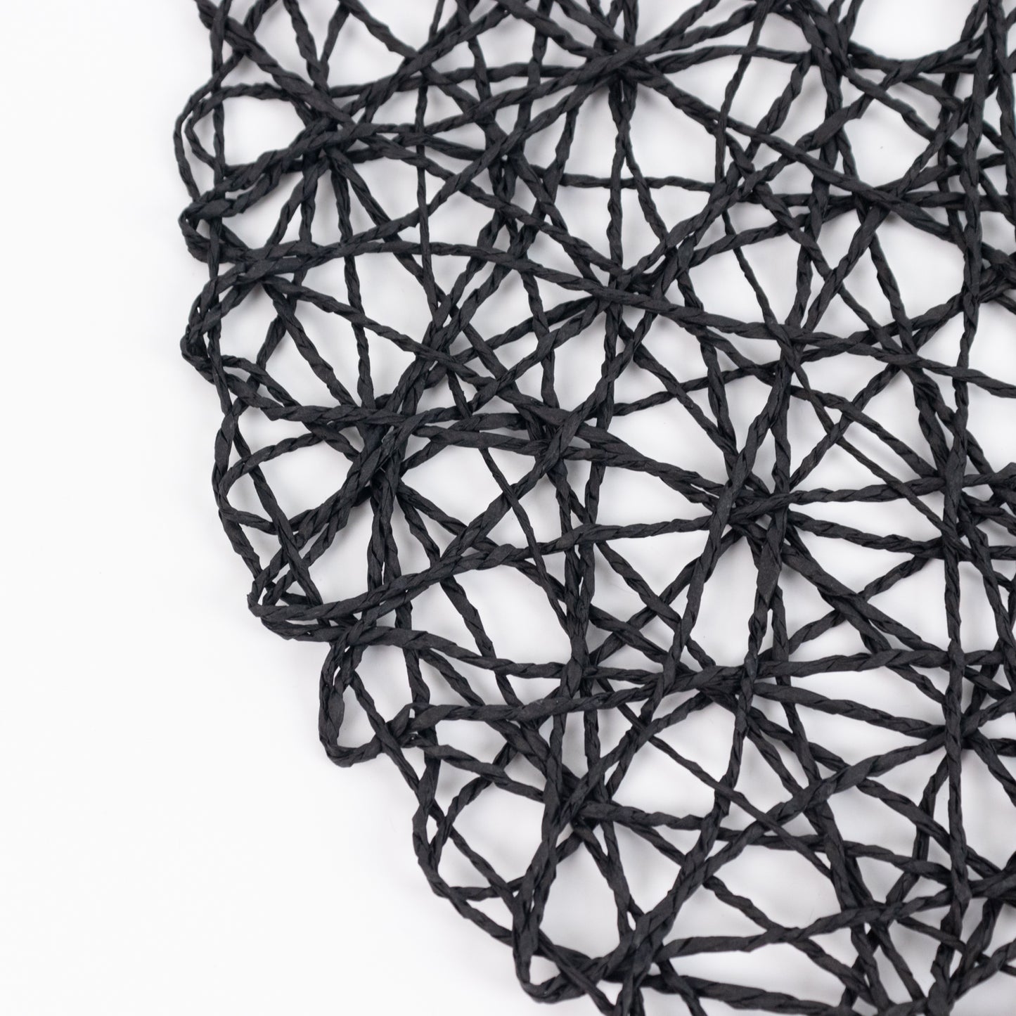 Dark blue woven fiber round placemat for dining events.