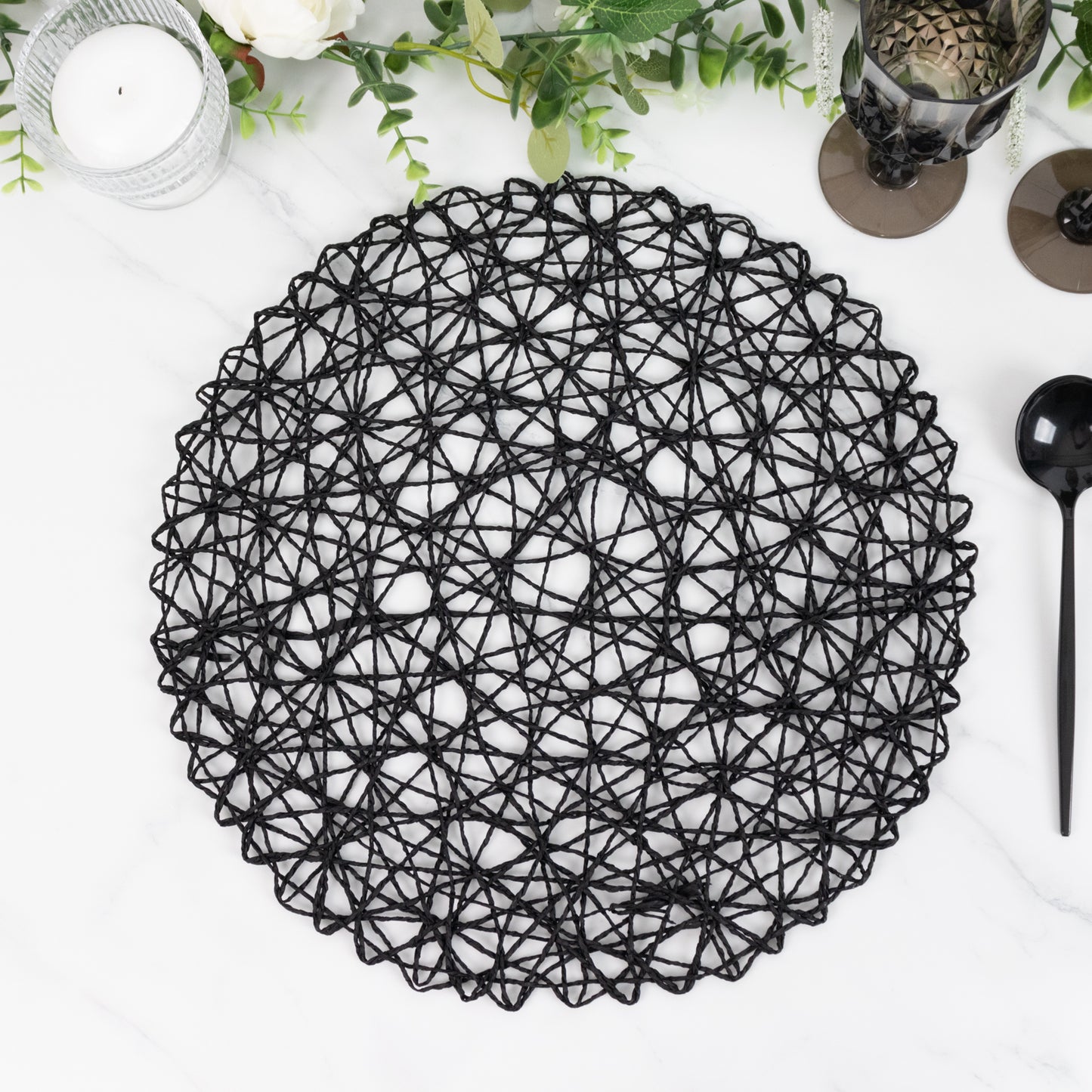 Black round woven fiber placemat for dining and events.