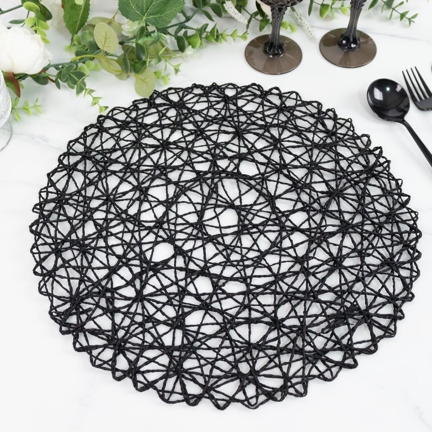 Black round woven fiber placemat for dining and events.