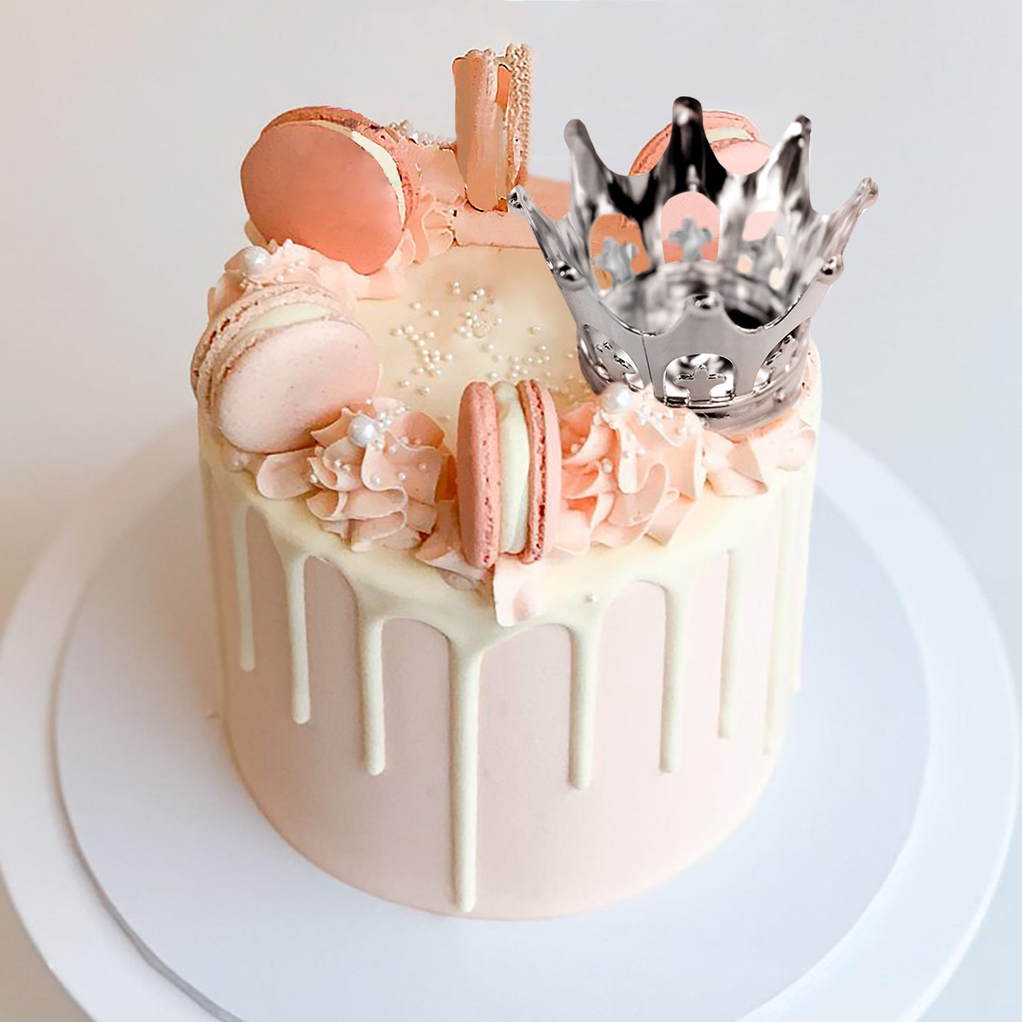 Silver fillable mini crown candy treat container on a cake.