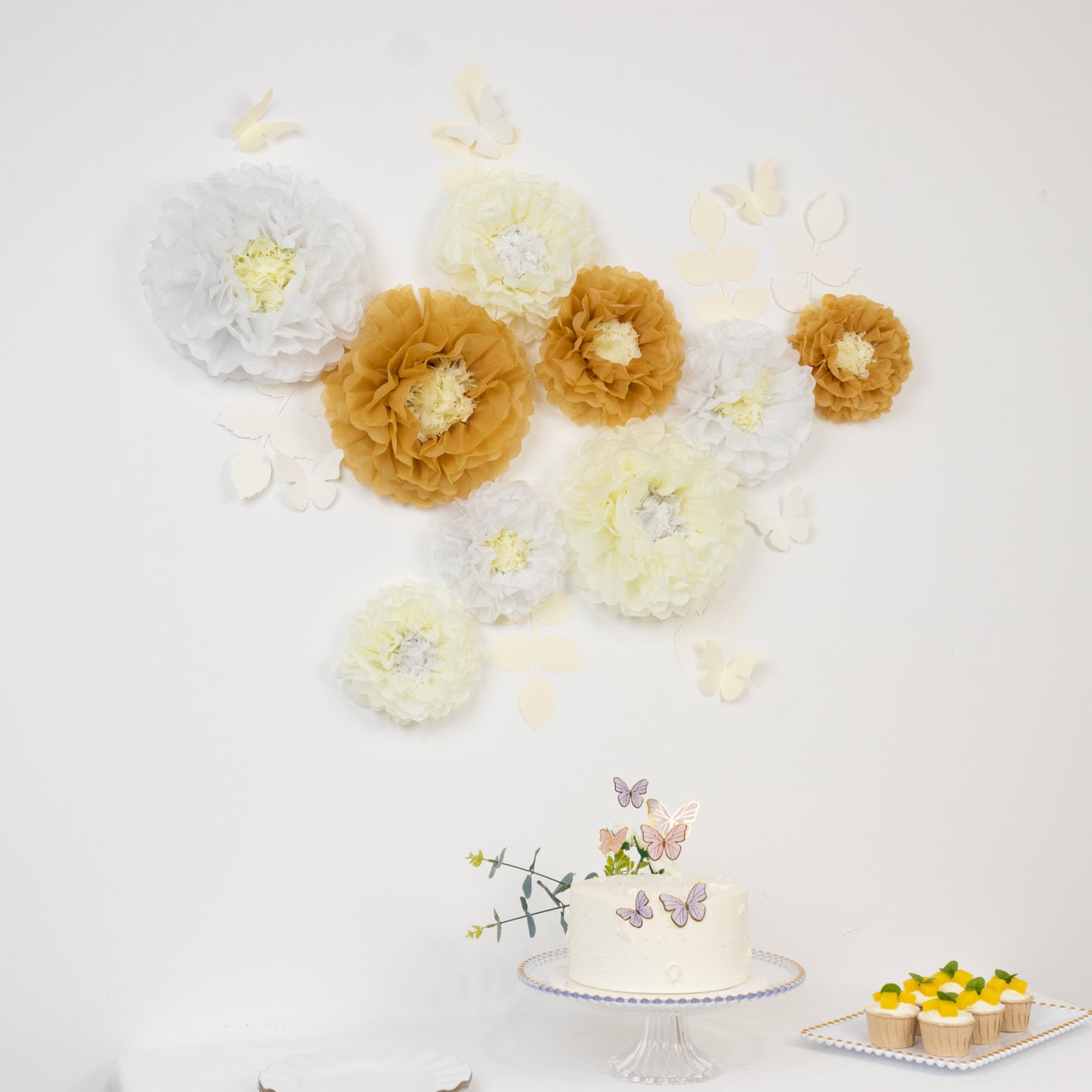 Set of 21 tissue paper flowers in white and ivory with butterflies and leaves.