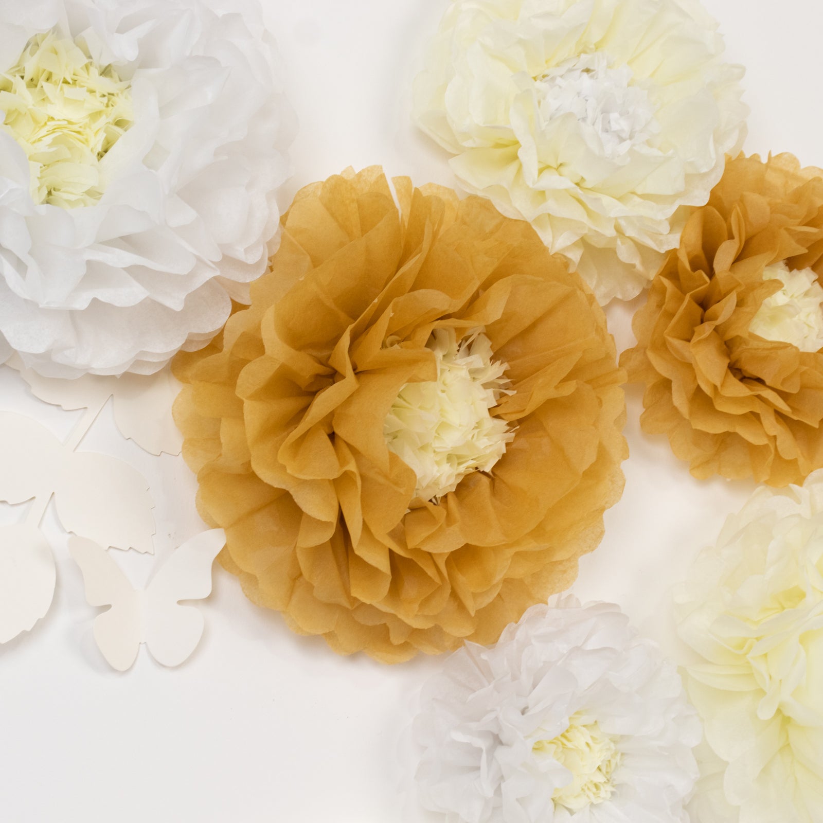 Set of 21 tissue paper flowers in white and ivory with butterflies and olive leaves.