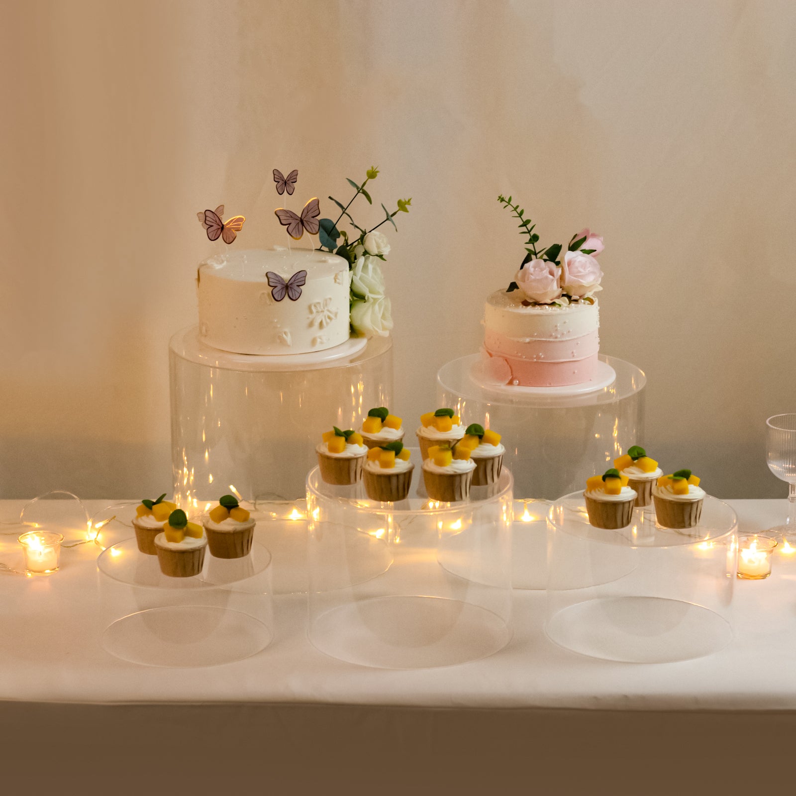Clear acrylic cake stands in a cylinder design, perfect for event displays.