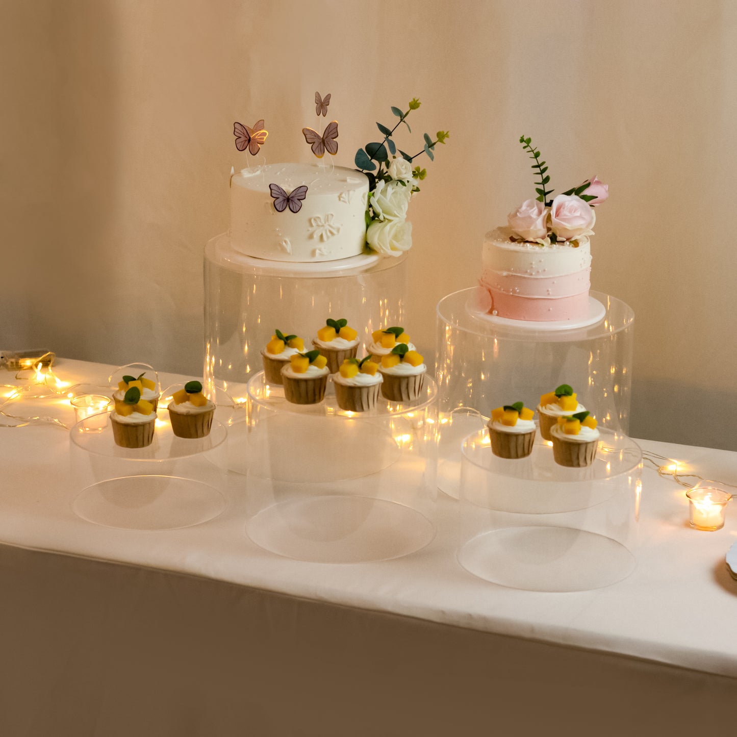 Clear acrylic cake stands in a cylinder design, perfect for event displays.