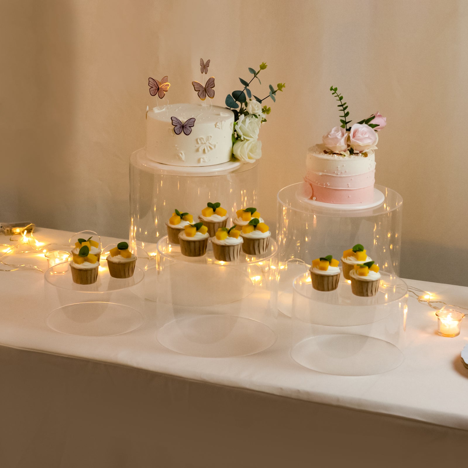 Clear acrylic cake stands in a cylinder design, perfect for event displays.