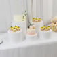 White acrylic cake stands in cylinder design for event displays.