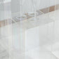Clear acrylic pedestal stands displayed on a marble surface with wine glasses.