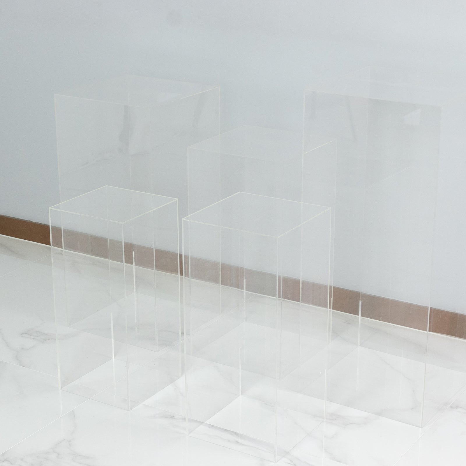 Clear acrylic pedestal stands set for displays, parties, and events.