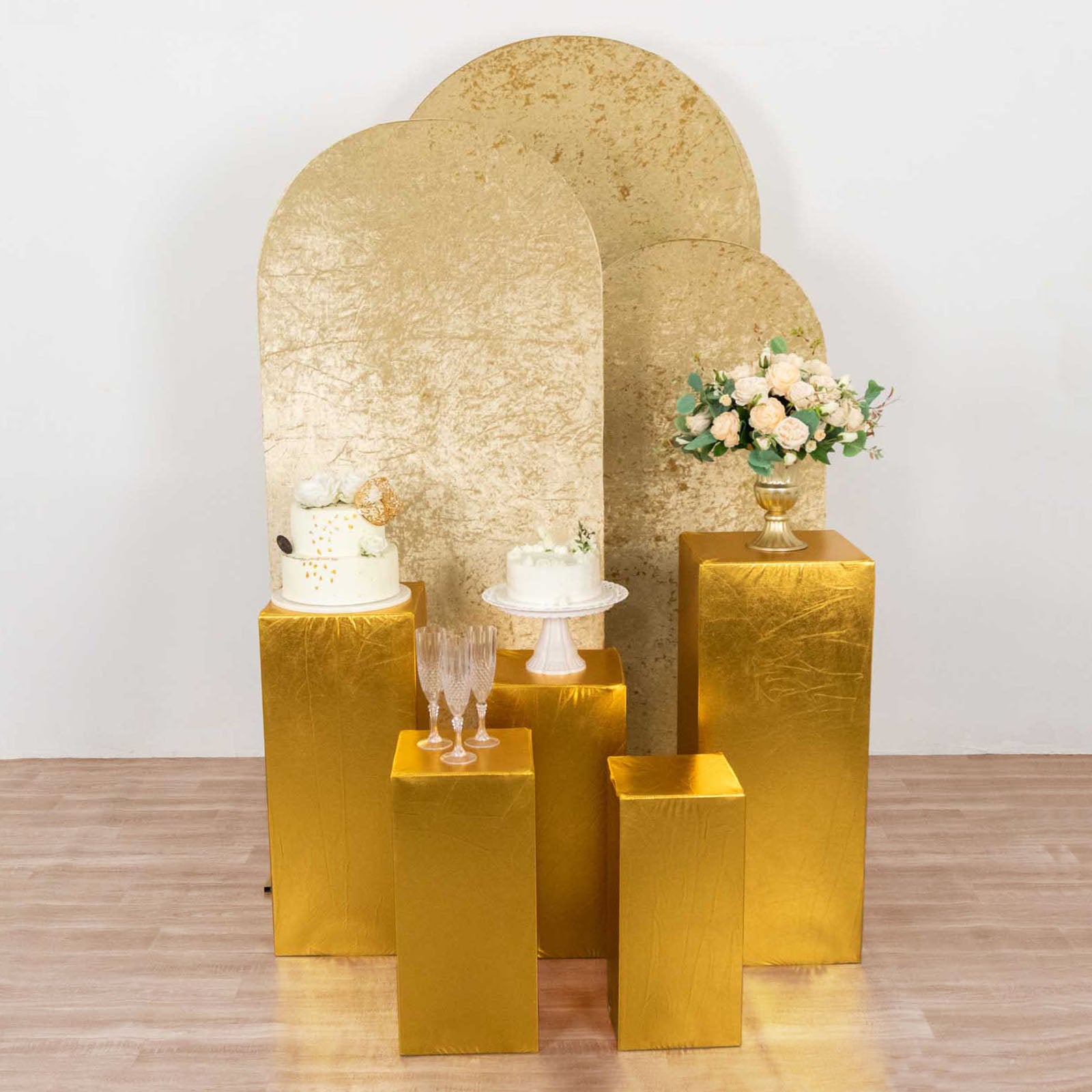 Metallic gold spandex pedestal stand covers for event decor.