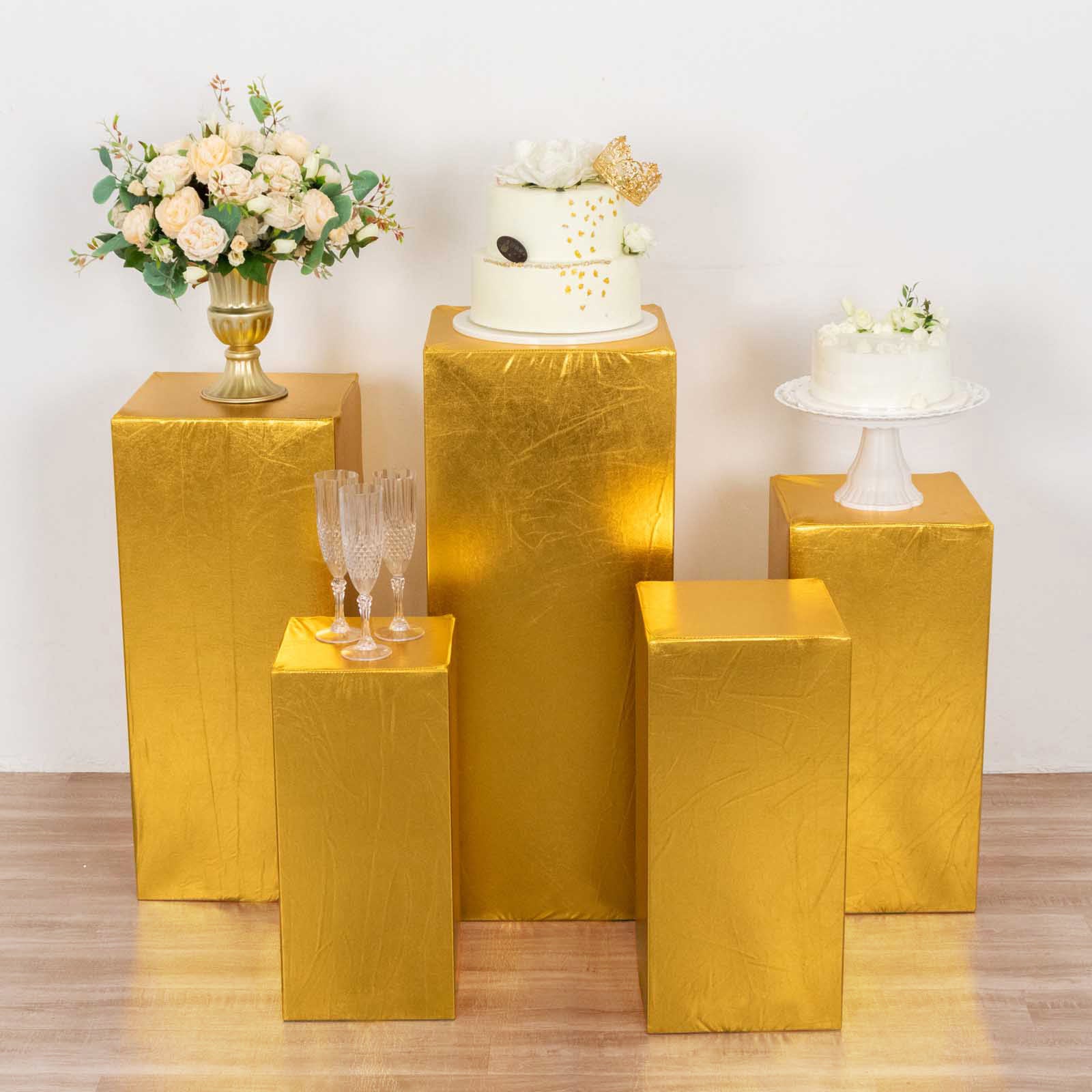 Metallic gold spandex pedestal stand covers for elegant displays.