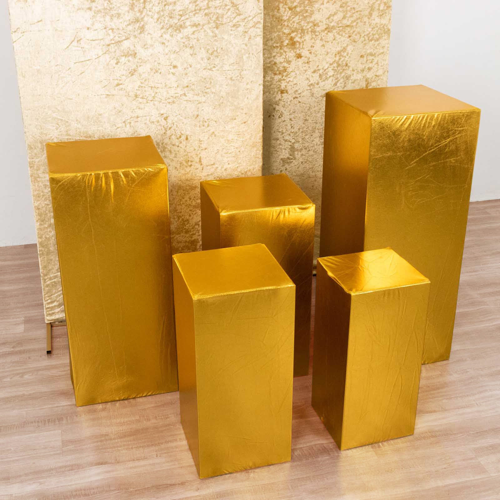 Set of 5 metallic gold spandex pedestal stand covers.