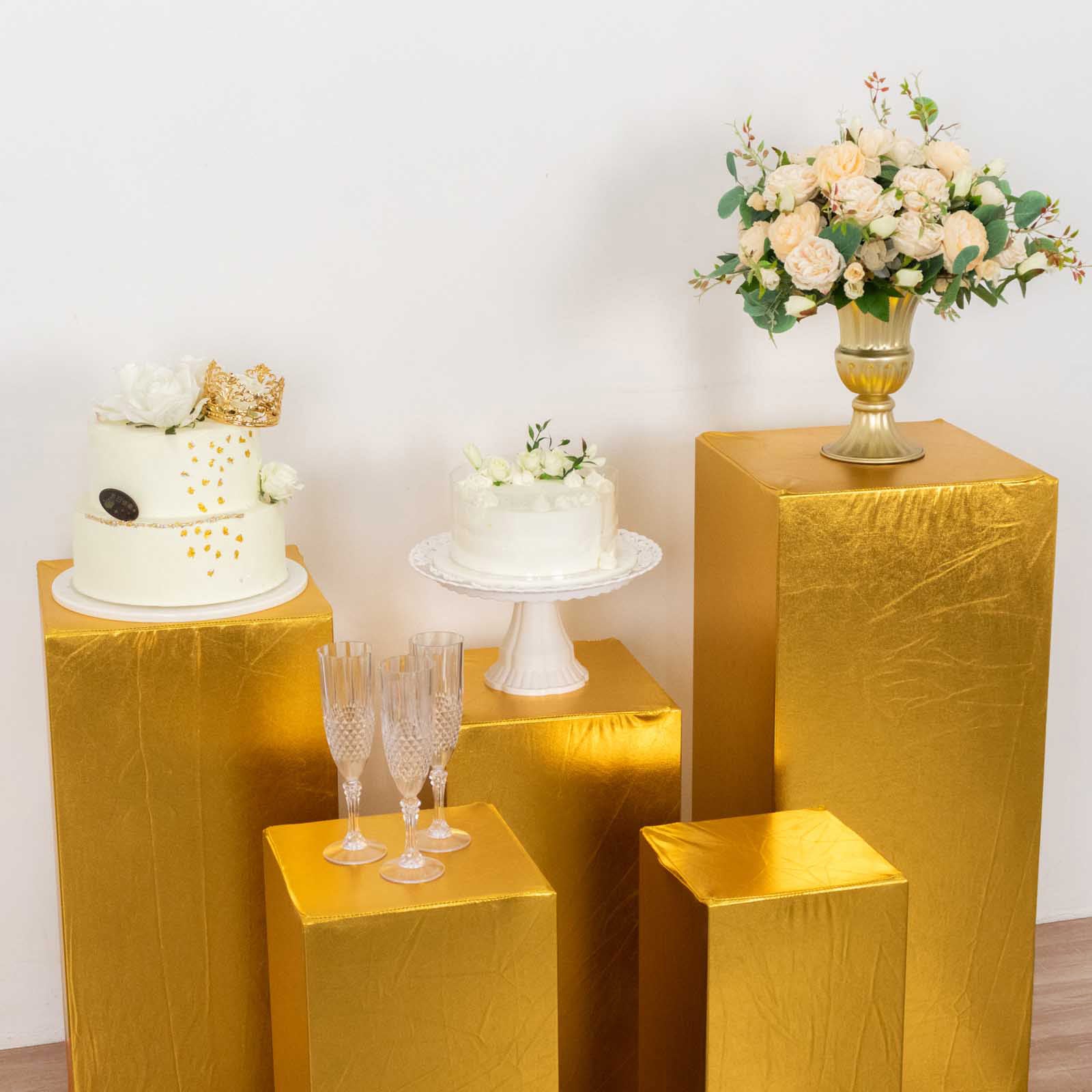 Metallic gold stretchable pedestal stand covers for events and displays.