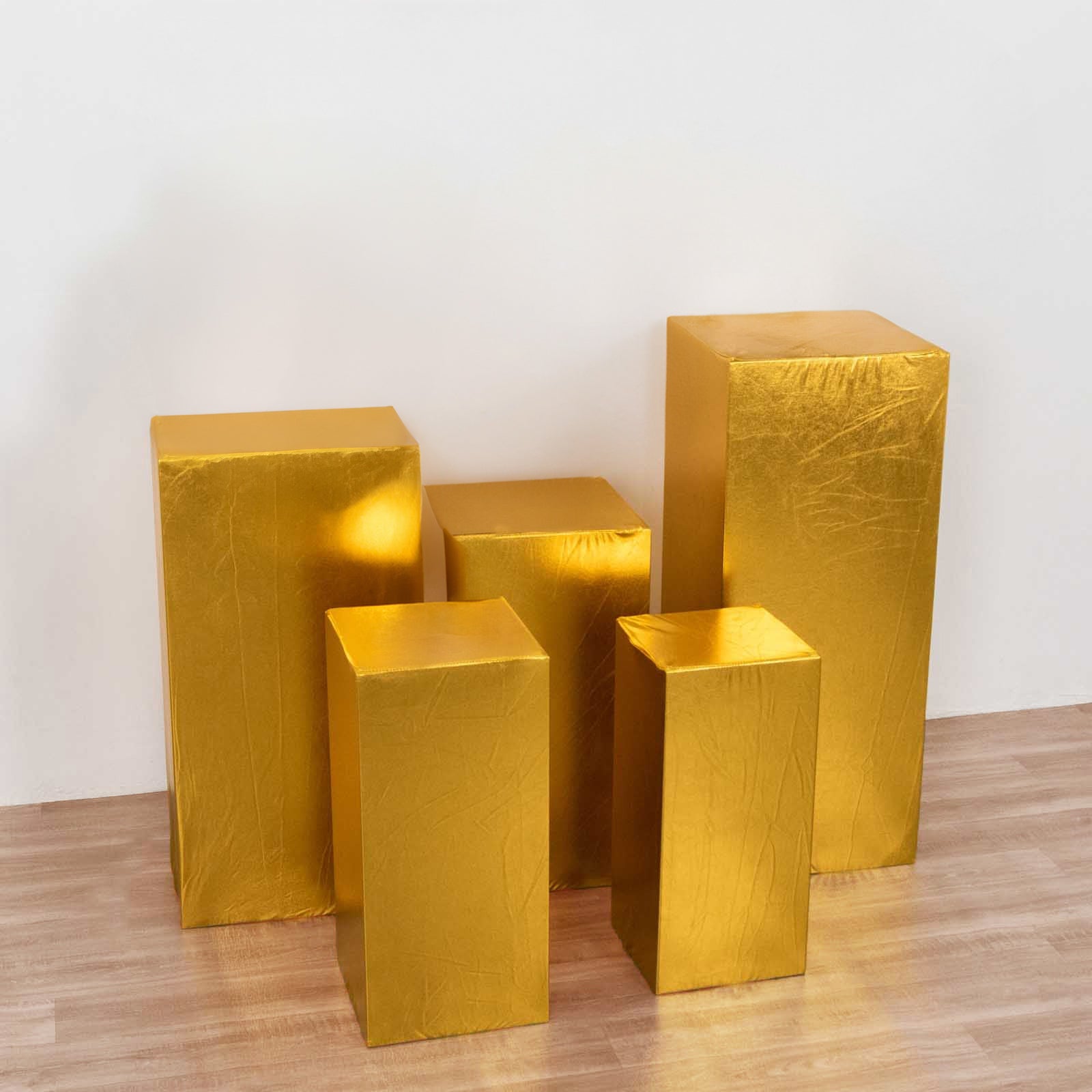 Set of 5 metallic gold pedestal stand covers for events and displays.