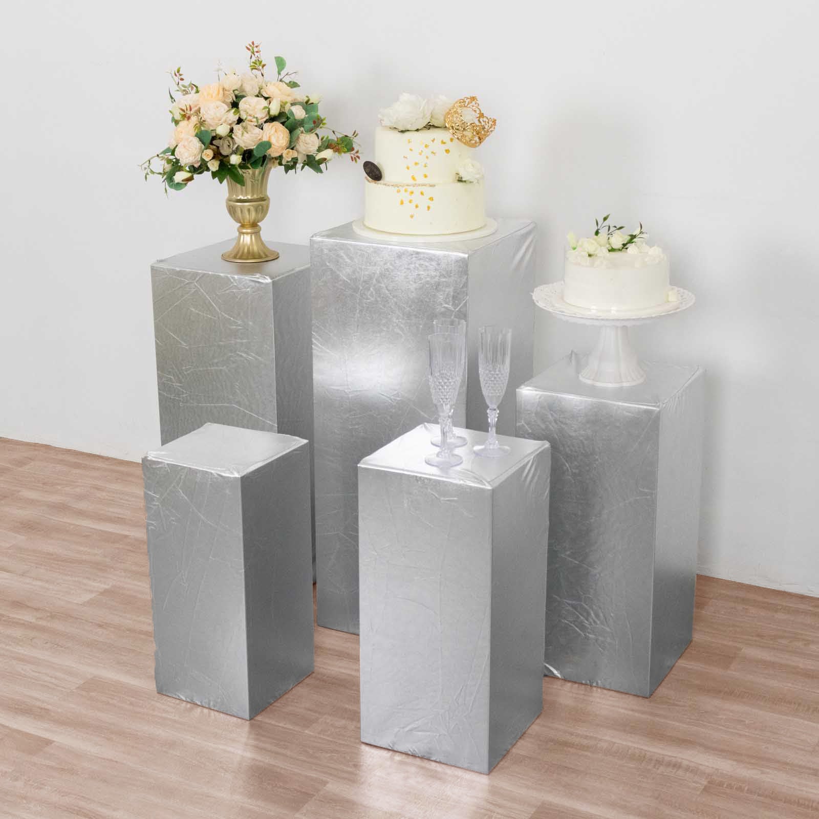Metallic silver stretchable pedestal stand covers for decorations.