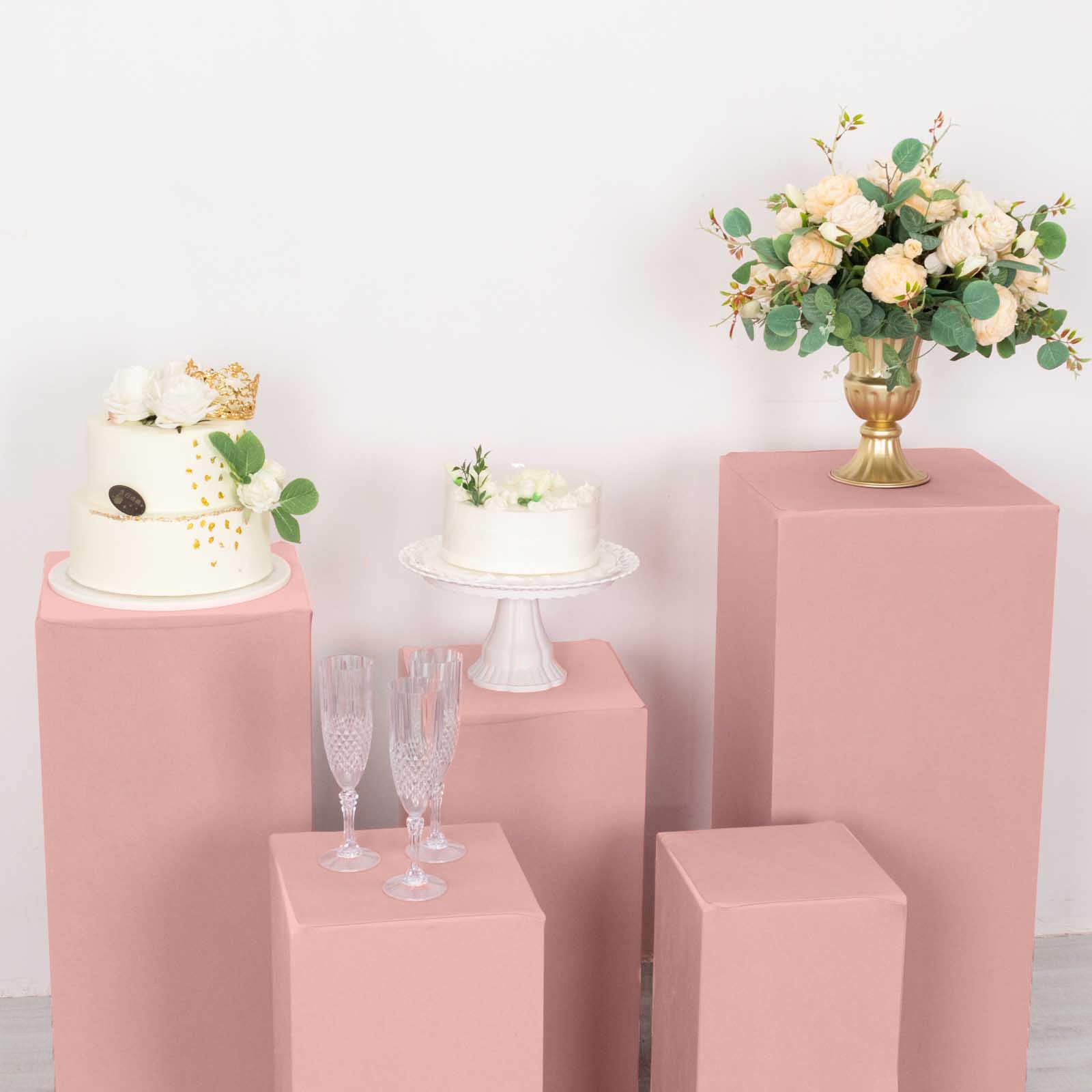 Dusty rose stretchable pedestal stand covers for events and displays.