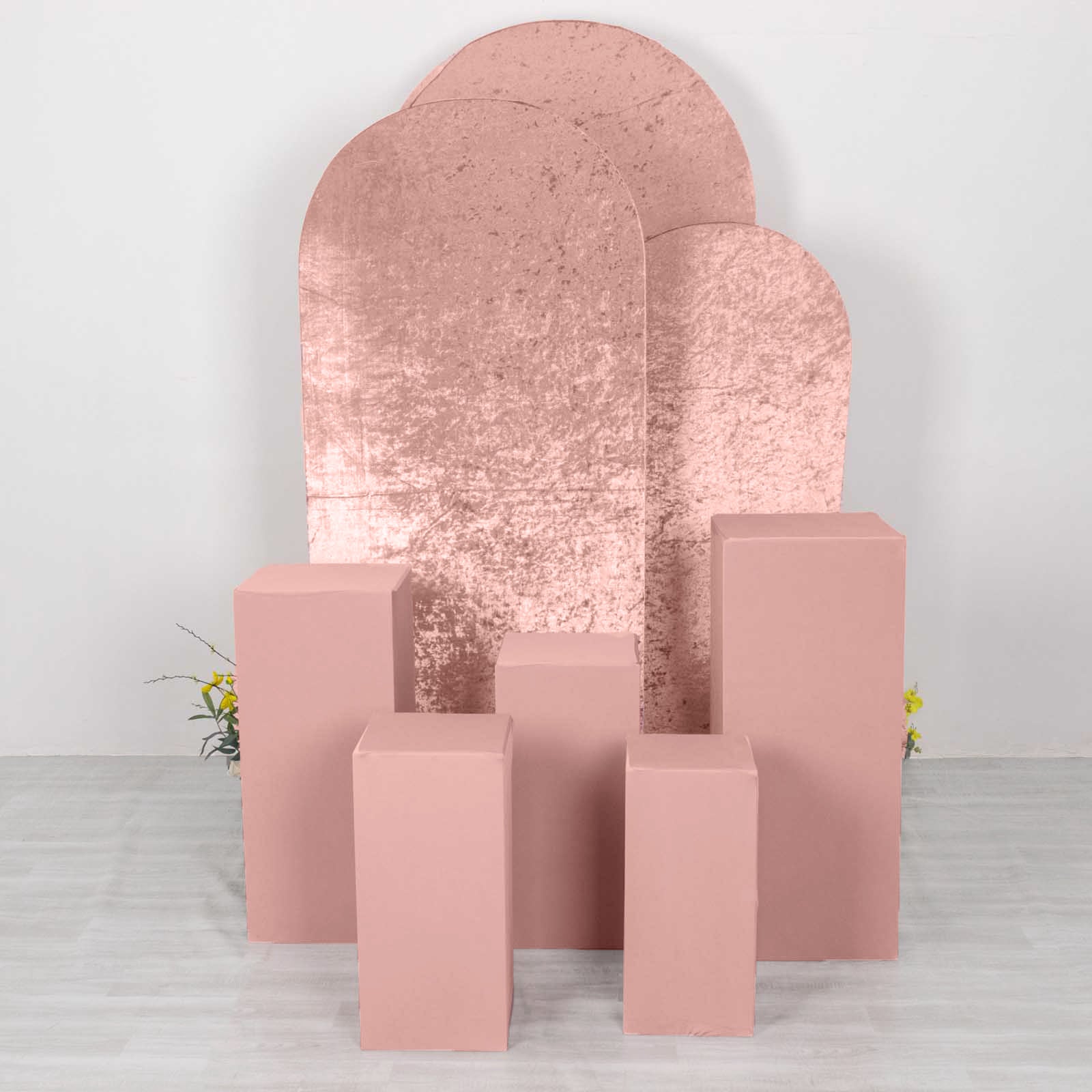 Dusty rose spandex pedestal stand covers for events and displays.