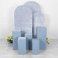 Dusty blue spandex pedestal stand covers for events and displays.