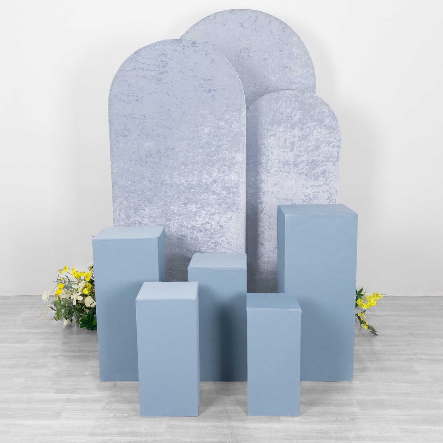 Dusty blue spandex pedestal stand covers for events and displays.