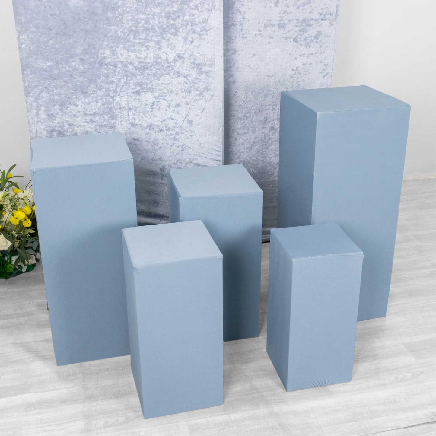 Set of 5 dusty blue stretchable pedestal stand covers.