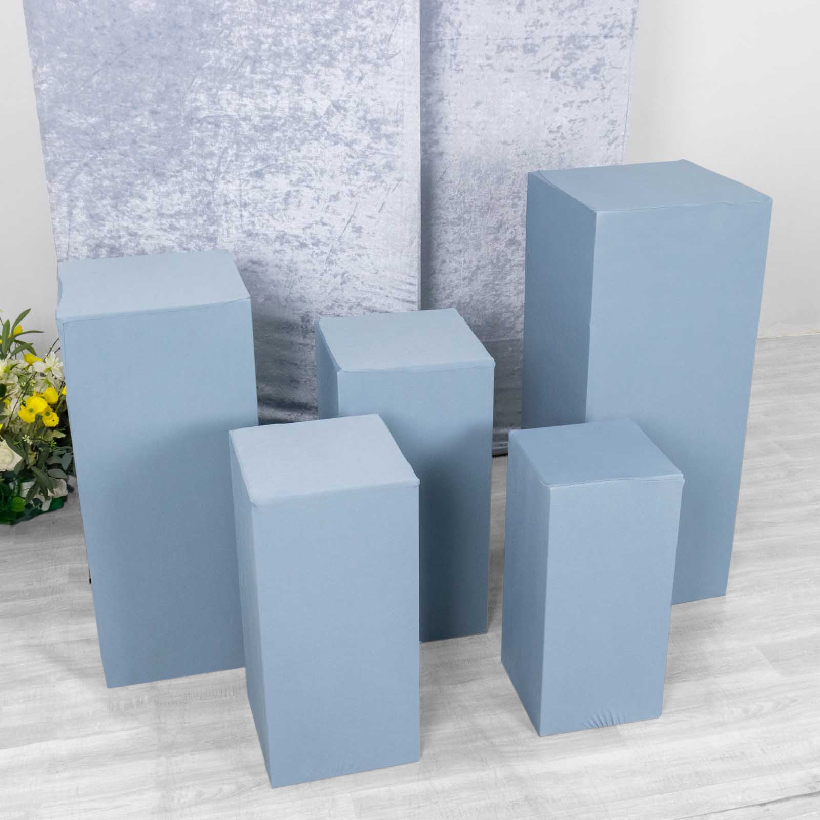 Set of 5 dusty blue stretchable pedestal stand covers.