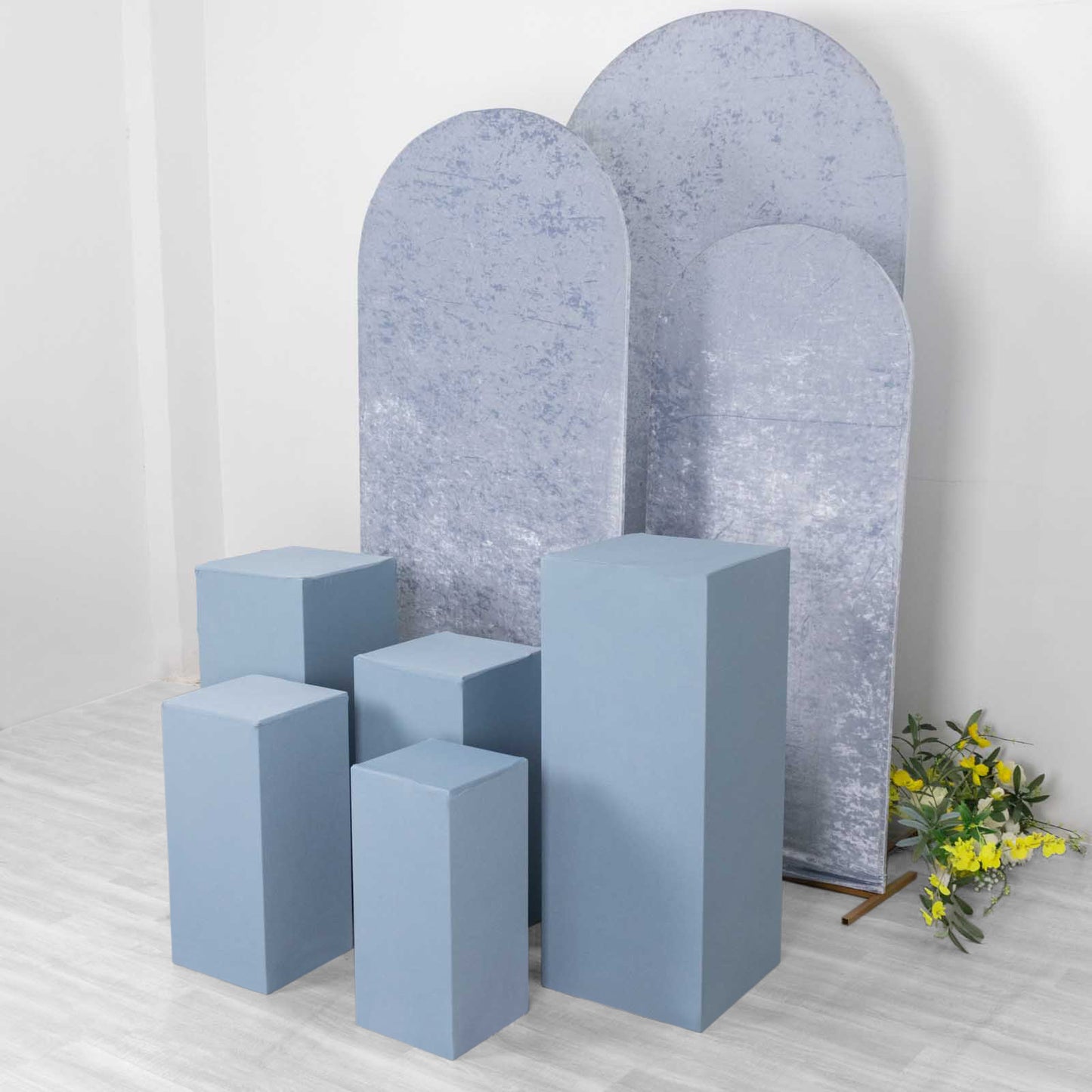 Dusty blue spandex pedestal stand covers in various sizes.