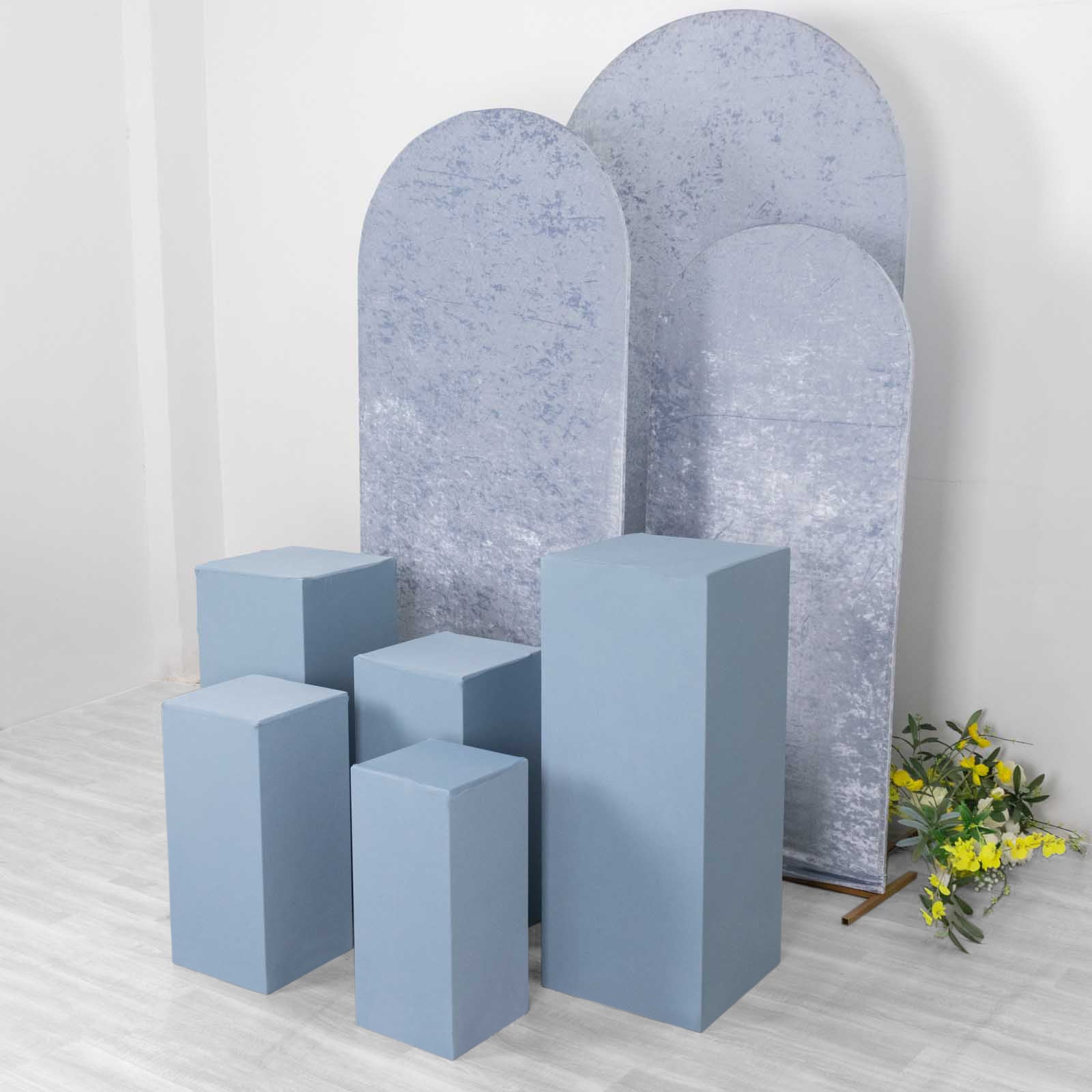 Dusty blue spandex pedestal stand covers in various sizes.