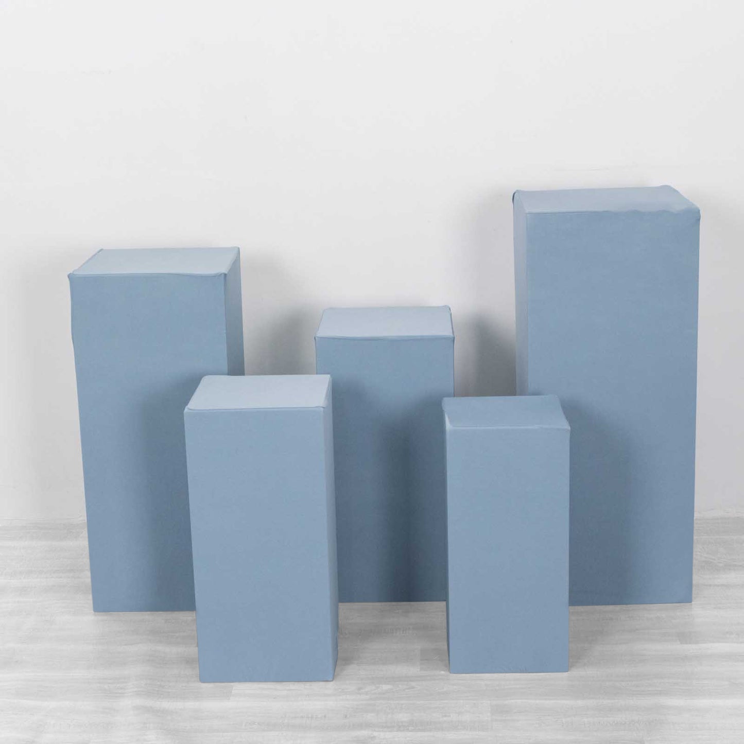Dusty blue spandex pedestal stand covers in various sizes.