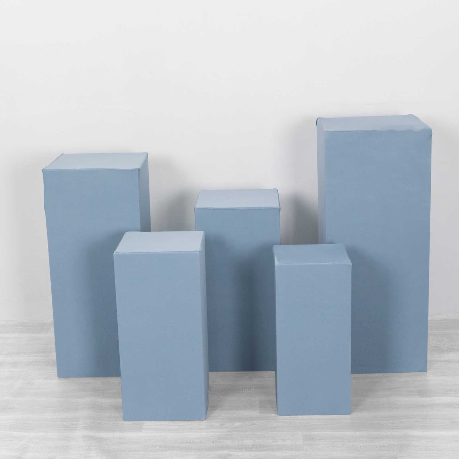 Dusty blue spandex pedestal stand covers in various sizes.