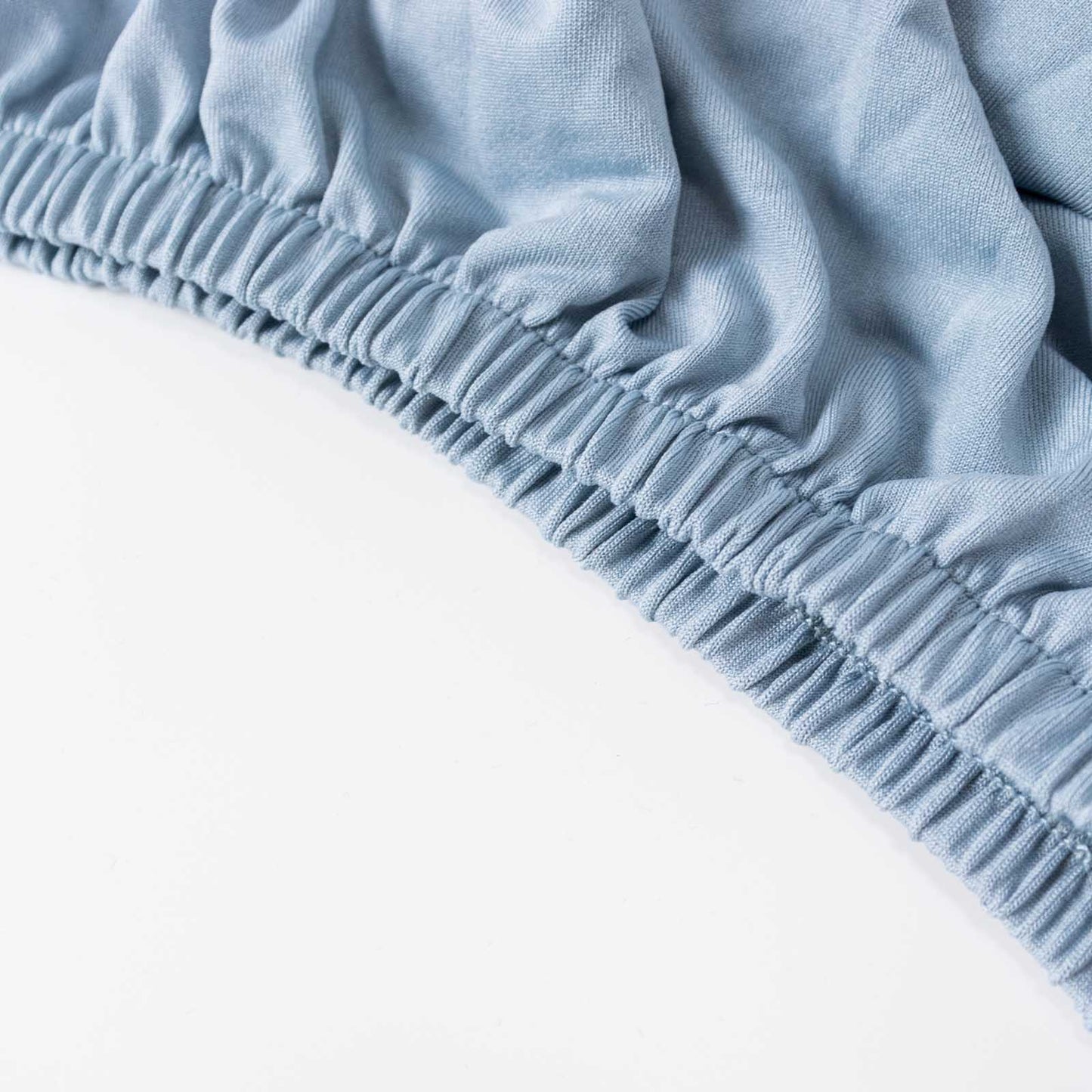 Dusty blue spandex pedestal stand cover with stretchable design.