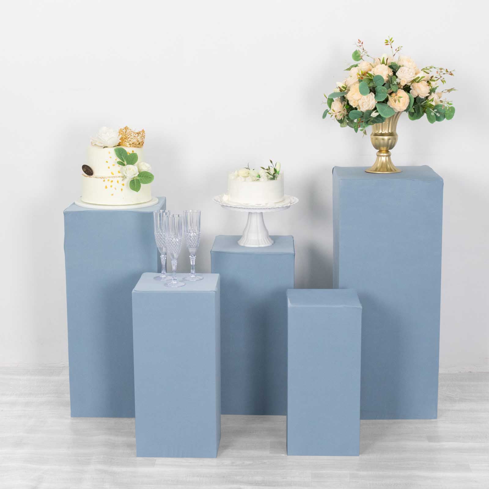 Dusty blue pedestal stand covers for decorative displays.