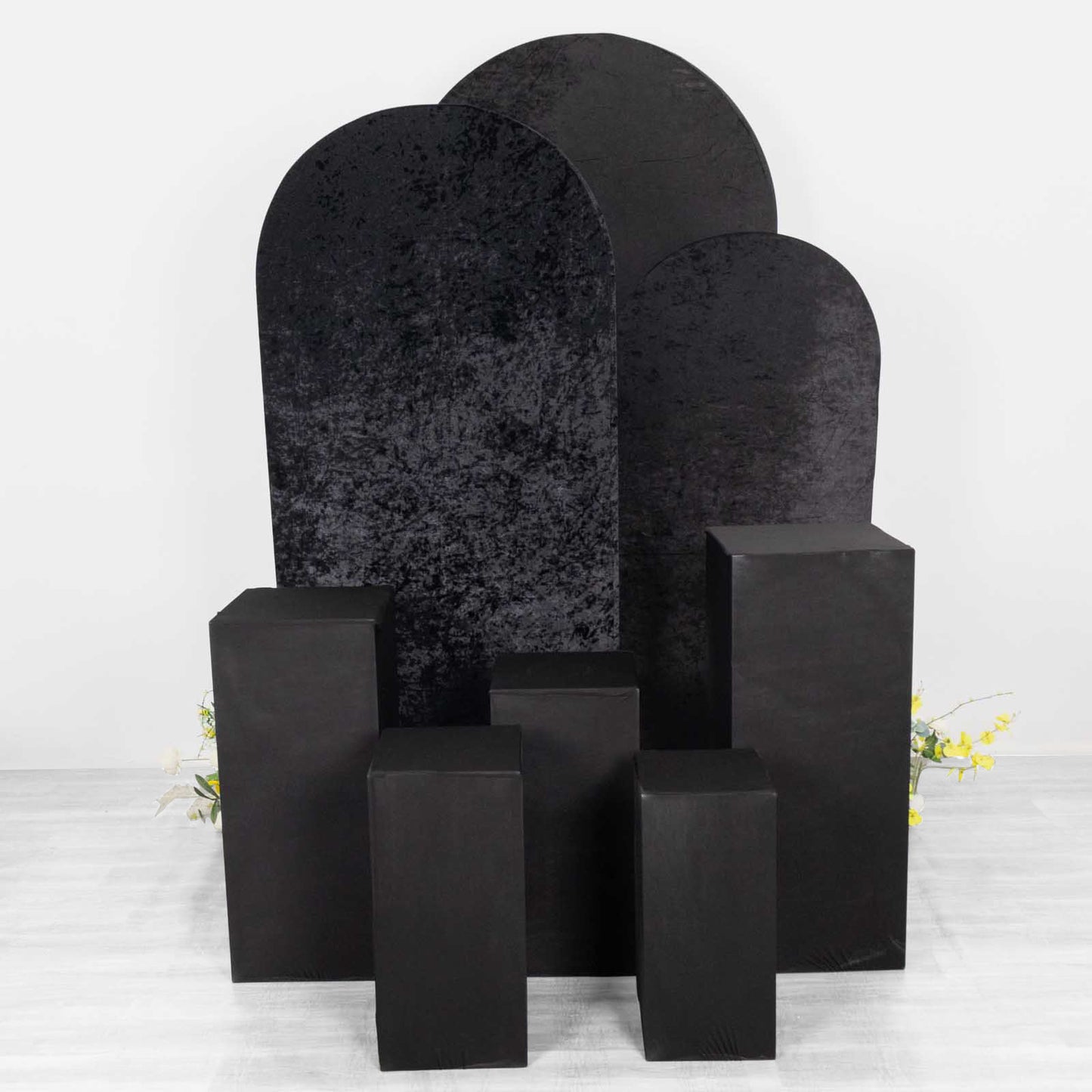 Set of 5 black spandex pedestal stand covers for events and displays.