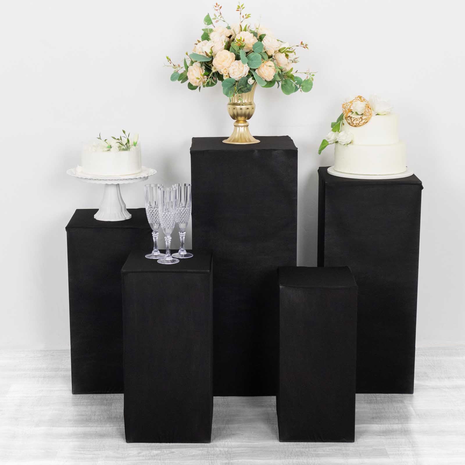 Black spandex pedestal stand covers for events and displays.