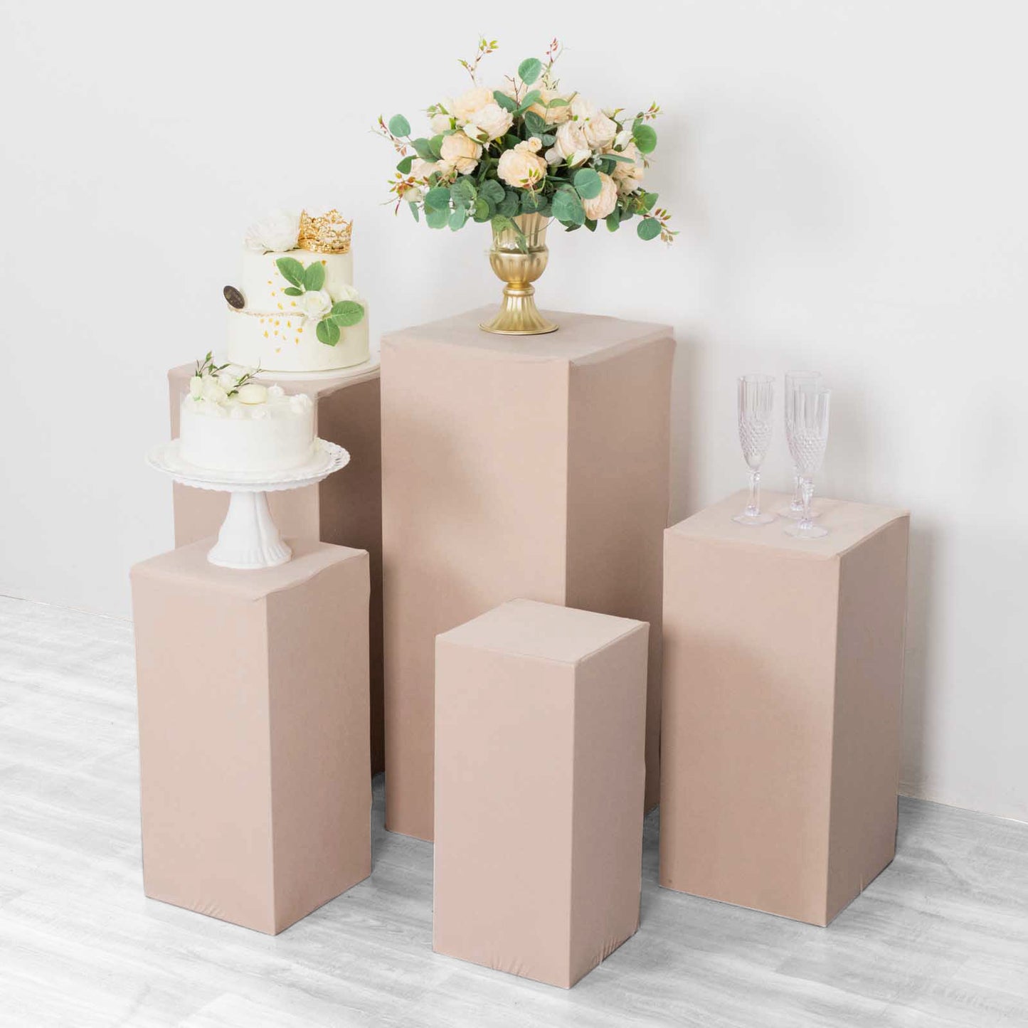 Nude spandex pedestal stand covers for events and displays.