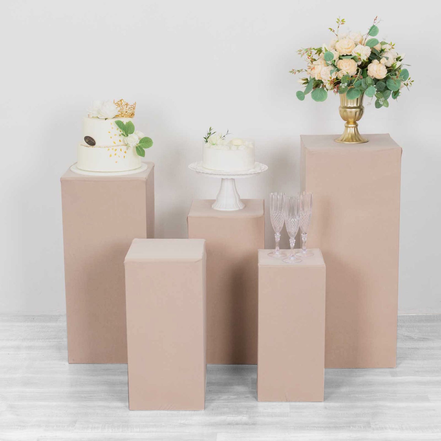 Nude spandex pedestal stand covers for events and displays.