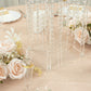Clear acrylic flower pedestal stand with hanging crystal beads and floral arrangements.
