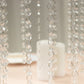 Clear acrylic flower pedestal stand with hanging crystal beads.