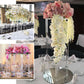 Clear acrylic wedding centerpiece vase with square mirror base and floral arrangements.