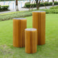 40" gold display column stand with top plate in a garden setting.