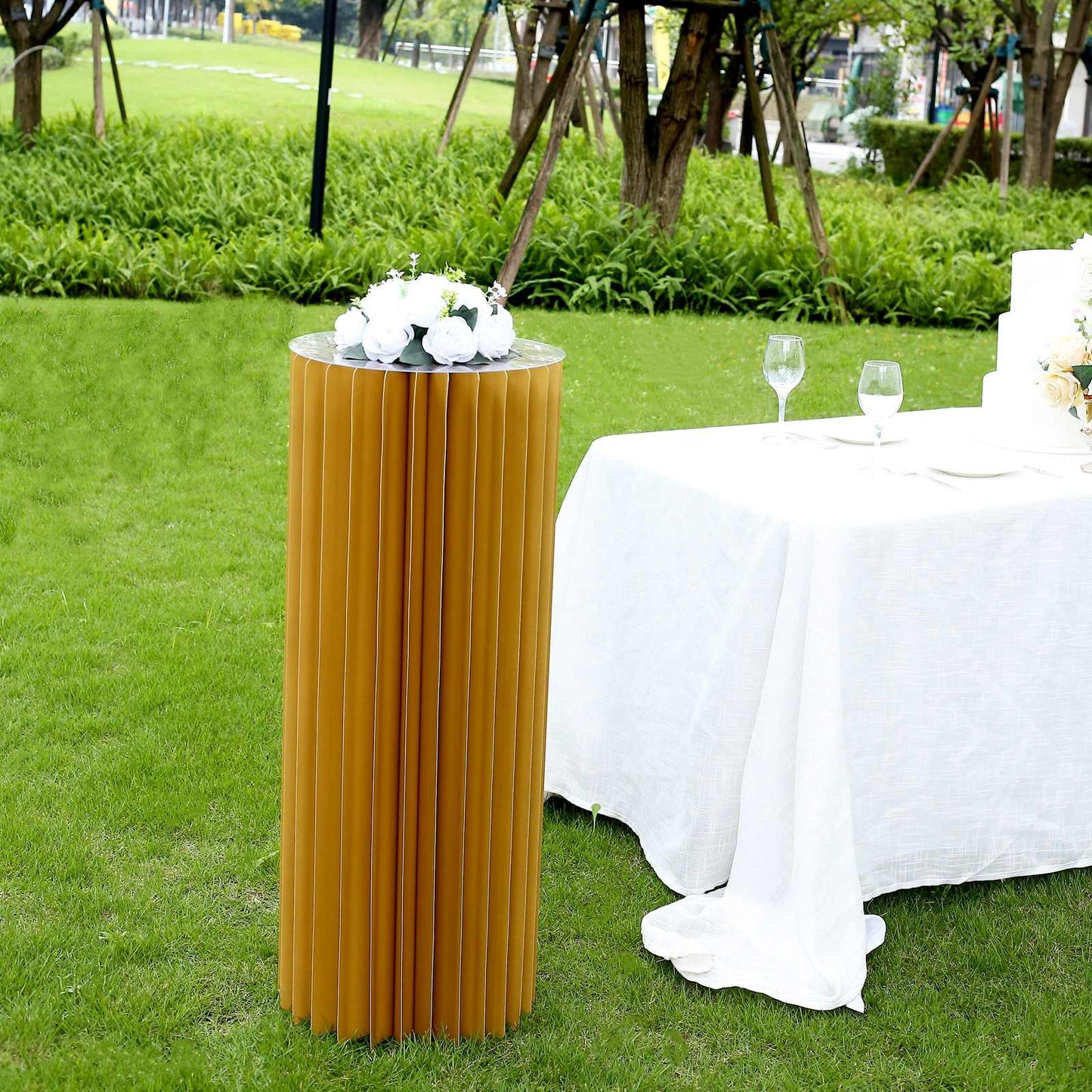 Gold cylinder display column stand with top plate, perfect for events or decor.